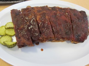 a plate of ribs and pickles