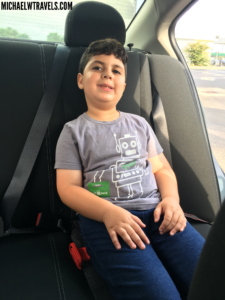 a boy sitting in a car