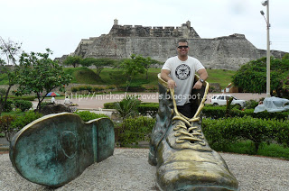 a man standing in a statue of a shoe