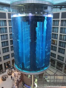 a large glass cylinder with blue water
