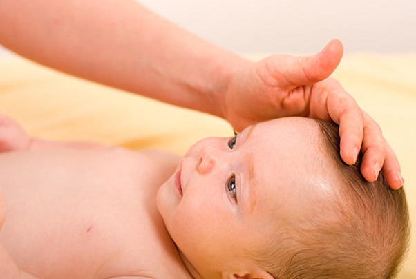 a baby being massaged by a hand
