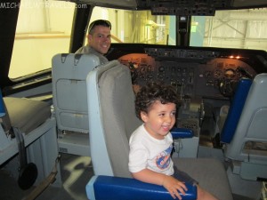 a man and child sitting in a plane