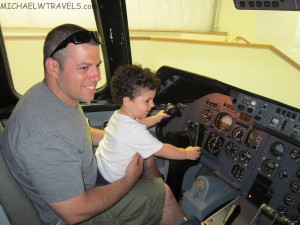 a man and child in a cockpit