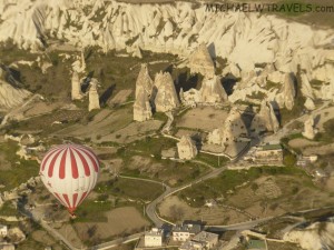 hot air balloons flying over a landscape