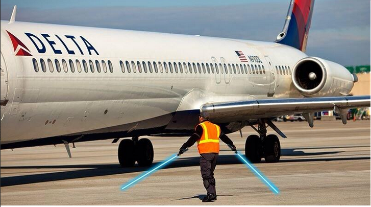 a man holding a light saber next to a plane