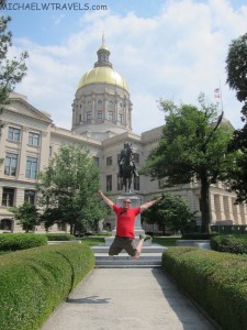 a man jumping in the air in front of Georgia State Capitol
