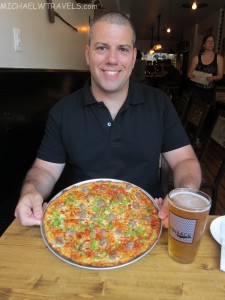 a man holding a pizza