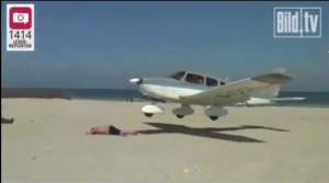 a plane landing on a beach