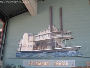 a painting of a steamboat on a wall