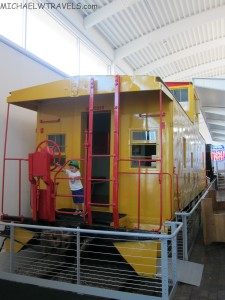 a child standing on a yellow train
