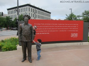 a child touching a statue
