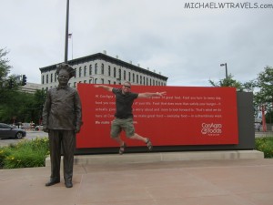 a man jumping in the air with a statue in front of him