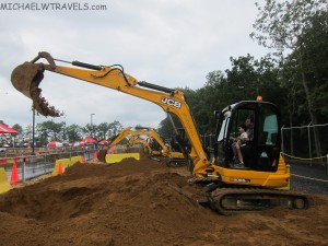 a group of construction vehicles digging a hole