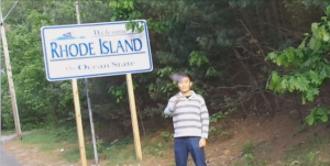 a man standing in front of a sign