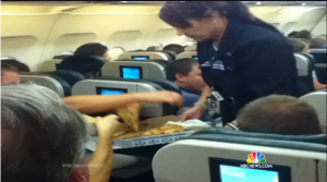 a woman serving food in a plane