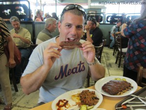 a man eating meat at a restaurant