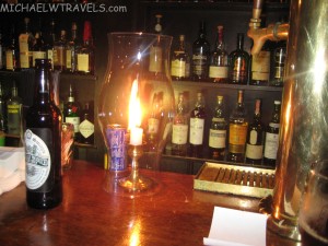 a candle in a glass on a bar