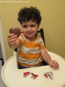 a child holding a chocolate heart