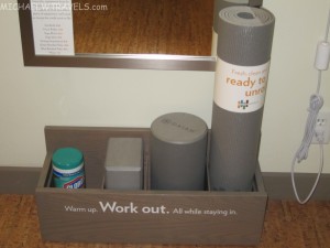 a grey yoga mat and a can of deodorant
