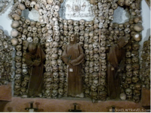 a group of skulls and statues