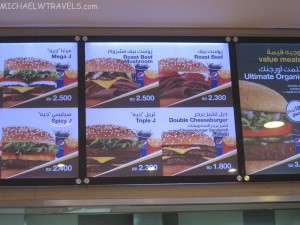a menu board with pictures of burgers