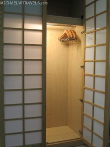 a closet with a swinger and paper doors