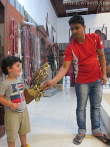 a man giving a bird to a boy