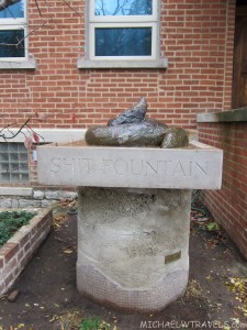 a stone fountain with a sign