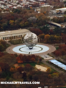 a globe sculpture in a circle surrounded by trees