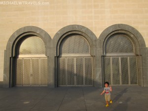 a child standing in front of a building