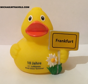 a yellow rubber duck with a sign