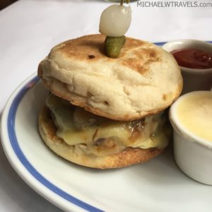 a plate of food with a burger and sauce