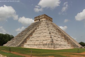 a pyramid with a square top with Chichen Itza in the background