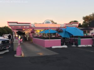 a pink building with blue umbrellas