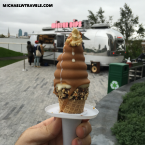 a hand holding a cone with a chocolate ice cream cone