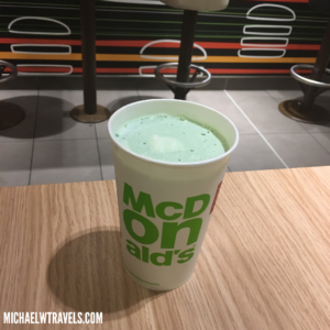 a cup of green liquid on a table