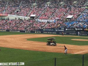 a baseball game with a golf cart in the middle of a field