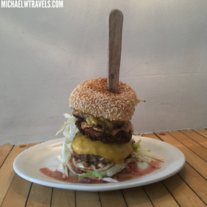 a burger with a wooden stick on it