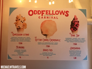 a sign with ice cream cones and prices