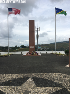 a monument with flags in the background