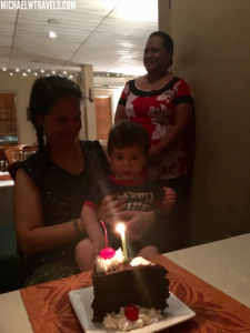 a woman and a child with a birthday cake