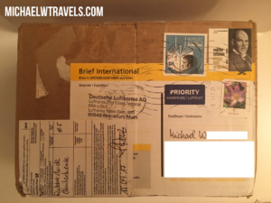 a cardboard box with stamps and a yellow tape
