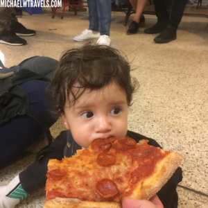 a child eating a slice of pizza