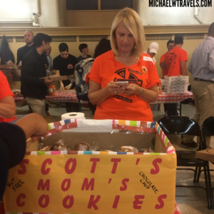 a woman standing next to a box of cookies