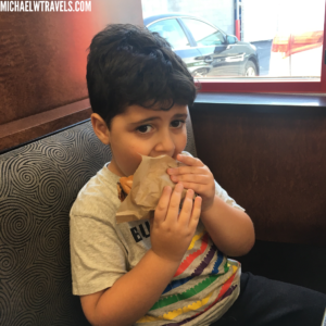a boy eating a hot dog
