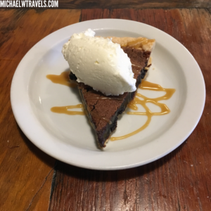a slice of pie with ice cream on top