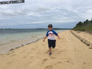 a boy running on a beach
