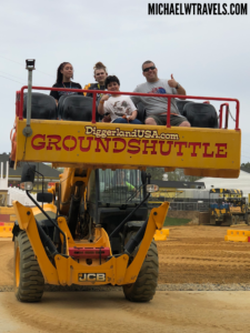 a group of people on a yellow tractor