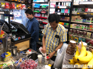 a man standing at a counter in a store