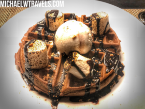 a waffle with ice cream and marshmallows on top
